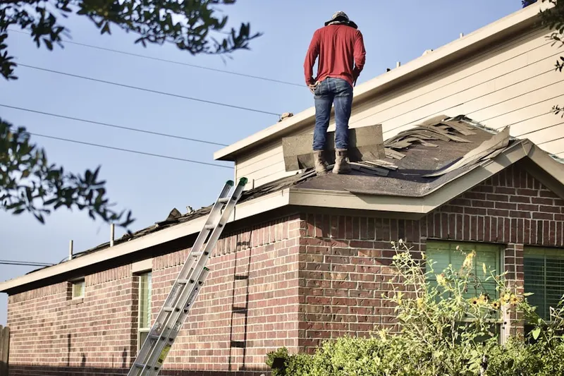 Professional roofer working on a residential roof in Holdrege